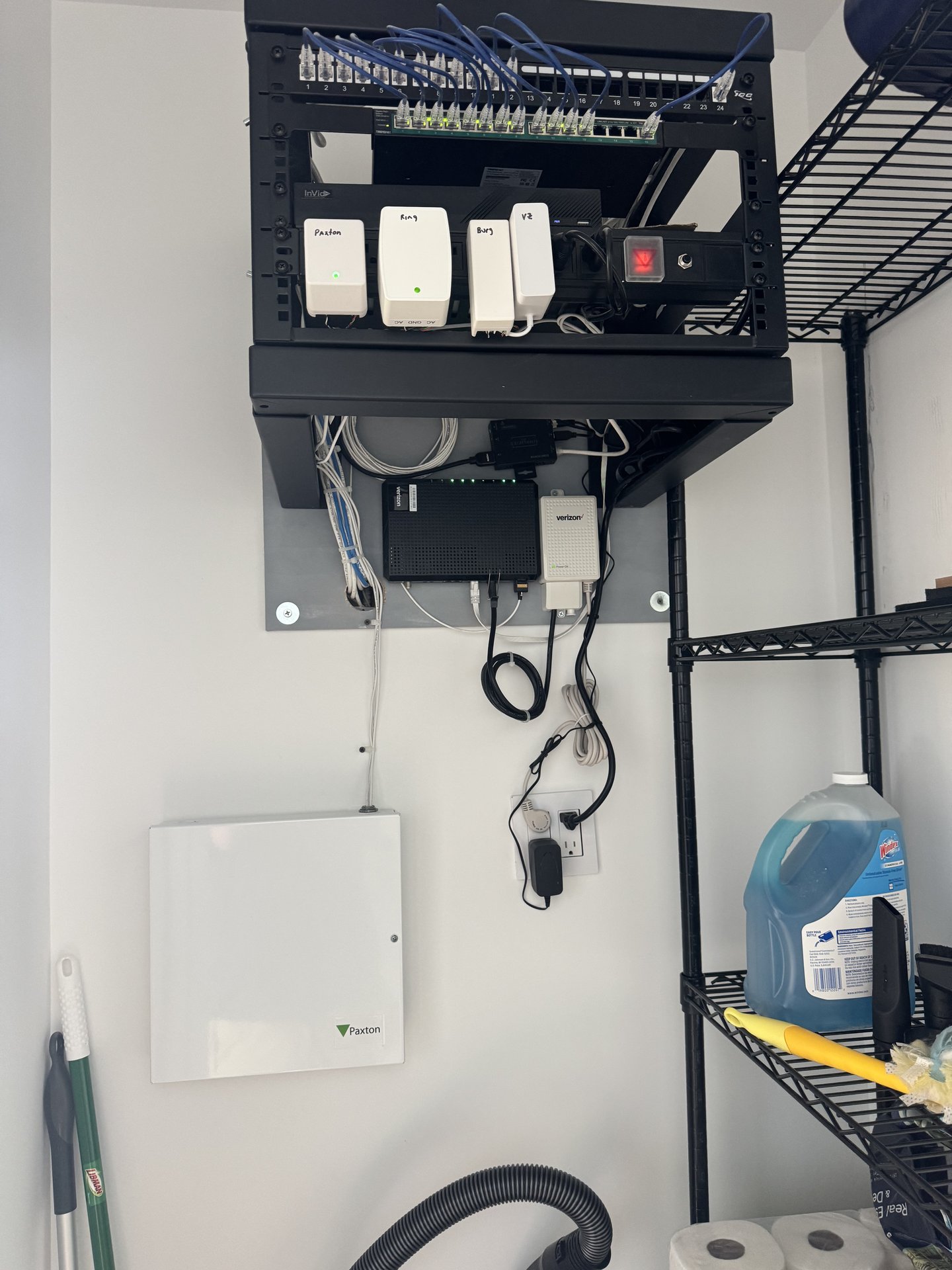 Structured network cabinet with patch panel, PoE injectors, and access control power supply installed for a real estate office in East Hills, NY