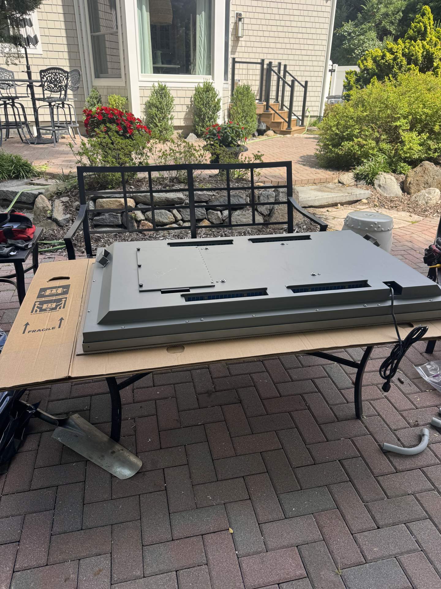 Weatherproof outdoor TV mounting plate and hardware staged for installation in Northport, NY